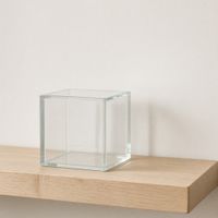 A glass cube on a shelf