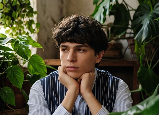 A thoughtful young man among plants